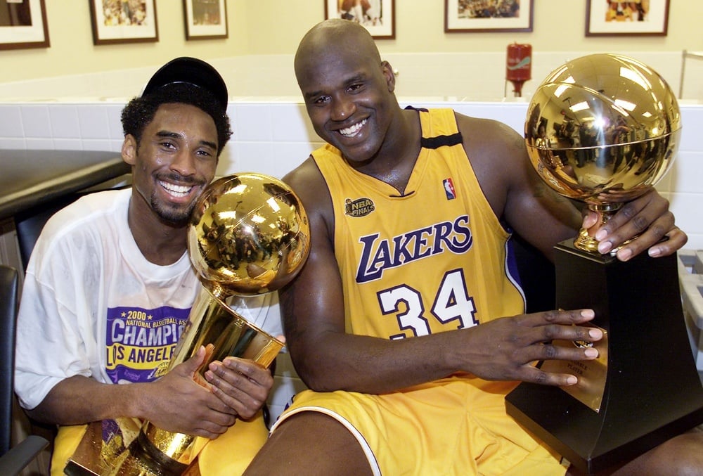 LOS ANGELES, UNITED STATES:  Kobe Bryant (L) of the Los Angeles Lakers holds the Larry O