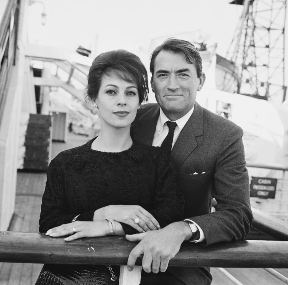 French-American journalist Veronique Peck (1932-2012) and her husband, American actor Gregory Peck (1916-2003), stand together by the guardrail of an unspecified ships, location unspecified, United Kingdom, 26th June 1962. (Photo by Evening Standard/Hulton Archive/Getty Images)