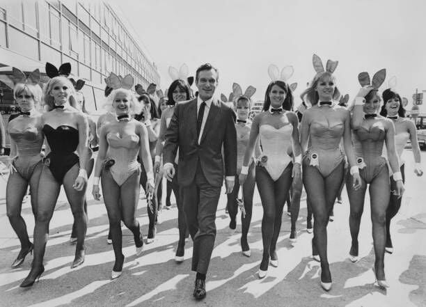 American publisher Hugh Hefner arrives at London Airport from Chicago with an entourage of Playboy Bunnies, 26th June 1966. He is in the capital for the opening of the London Playboy Club on Park Lane. (Photo by Ted West/Central Press/Hulton Archive/Getty Images)