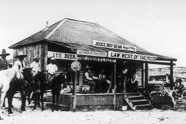 UNSPECIFIED - NOVEMBER 26: Judge Roy Bean (1825-1903, Law west of the Pecos) and his courthouse in a saloon along the Rio Grande River in a desolate stretch of the Chihuahuan Desert of West Texas c. 1870 (Photo by Apic/Getty Images)