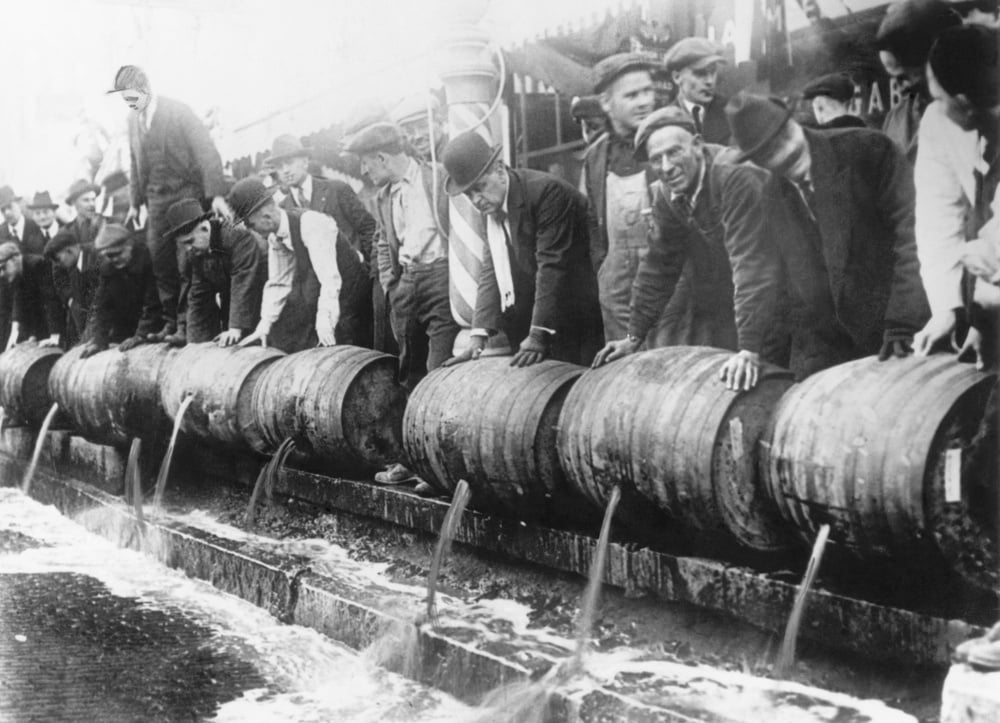 (Original Caption) Barrels of beer emptied into the sewer by authorities during prohibition. Undated photograph. BPA2# 4180 (Photo by George Rinhart/Corbis via Getty Images)