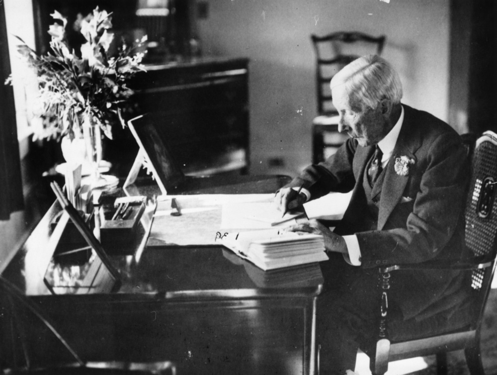 circa 1930:  American oil magnate and philanthropist, John Davidson Rockefeller (1839 - 1937) at work in his study.  (Photo by Hulton Archive/Getty Images)