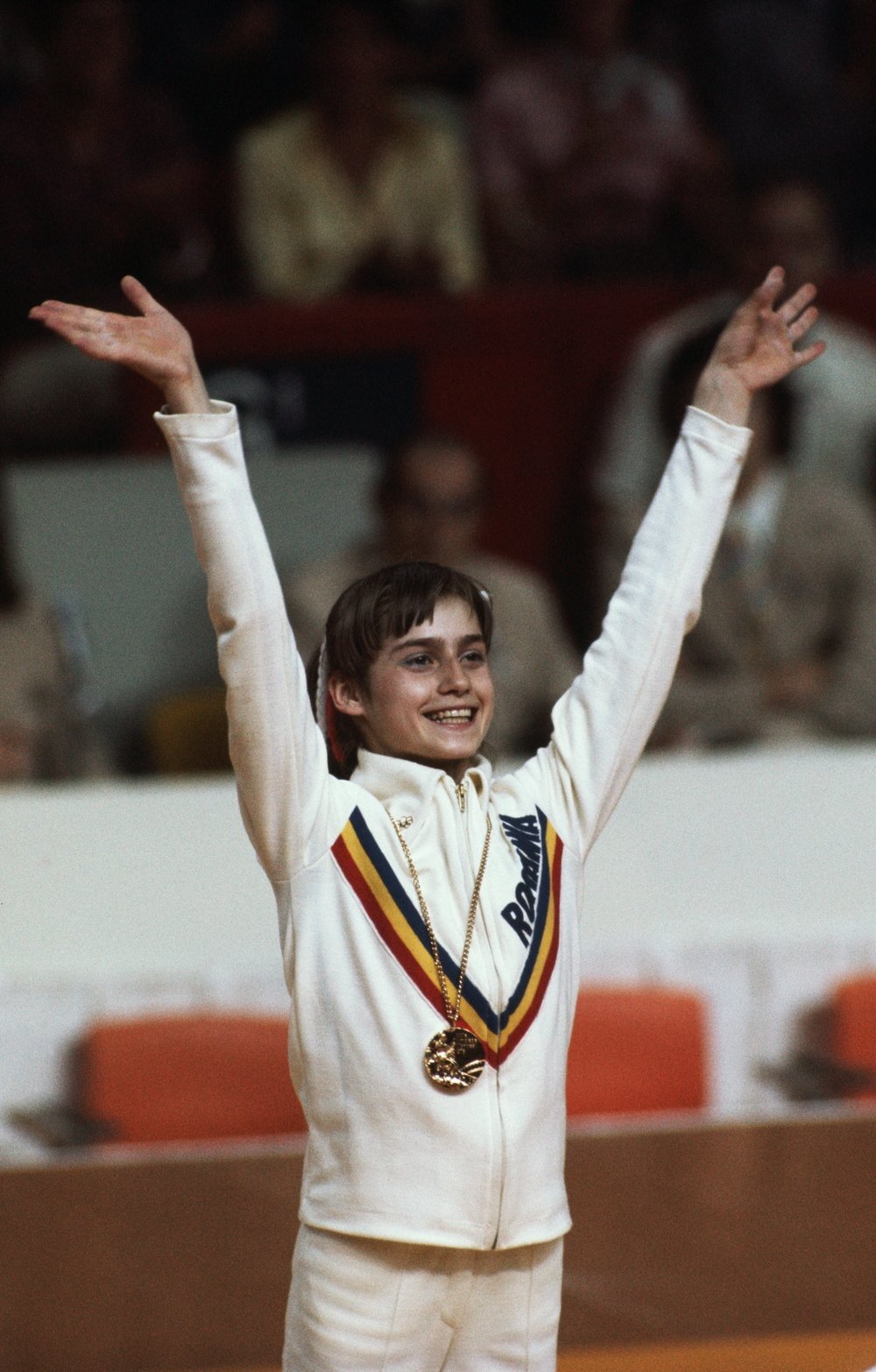 Nadia Comaneci with one of the three gold medals she won at the Montreal Olympics, July 1976. (Photo by © Wally McNamee/CORBIS/Corbis via Getty Images)