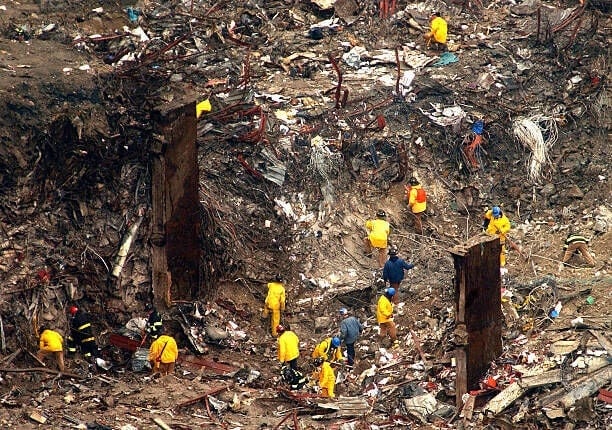 402285 02: New York City firefighters, police and others search the debris field March 13, 2002, at the site of the World Trade Center terrorist attacks in New York City, a day after the remains of 11 firefighters and two civilians were recovered in an area that was the south tower. (Photo by Spencer Platt/Getty Images)